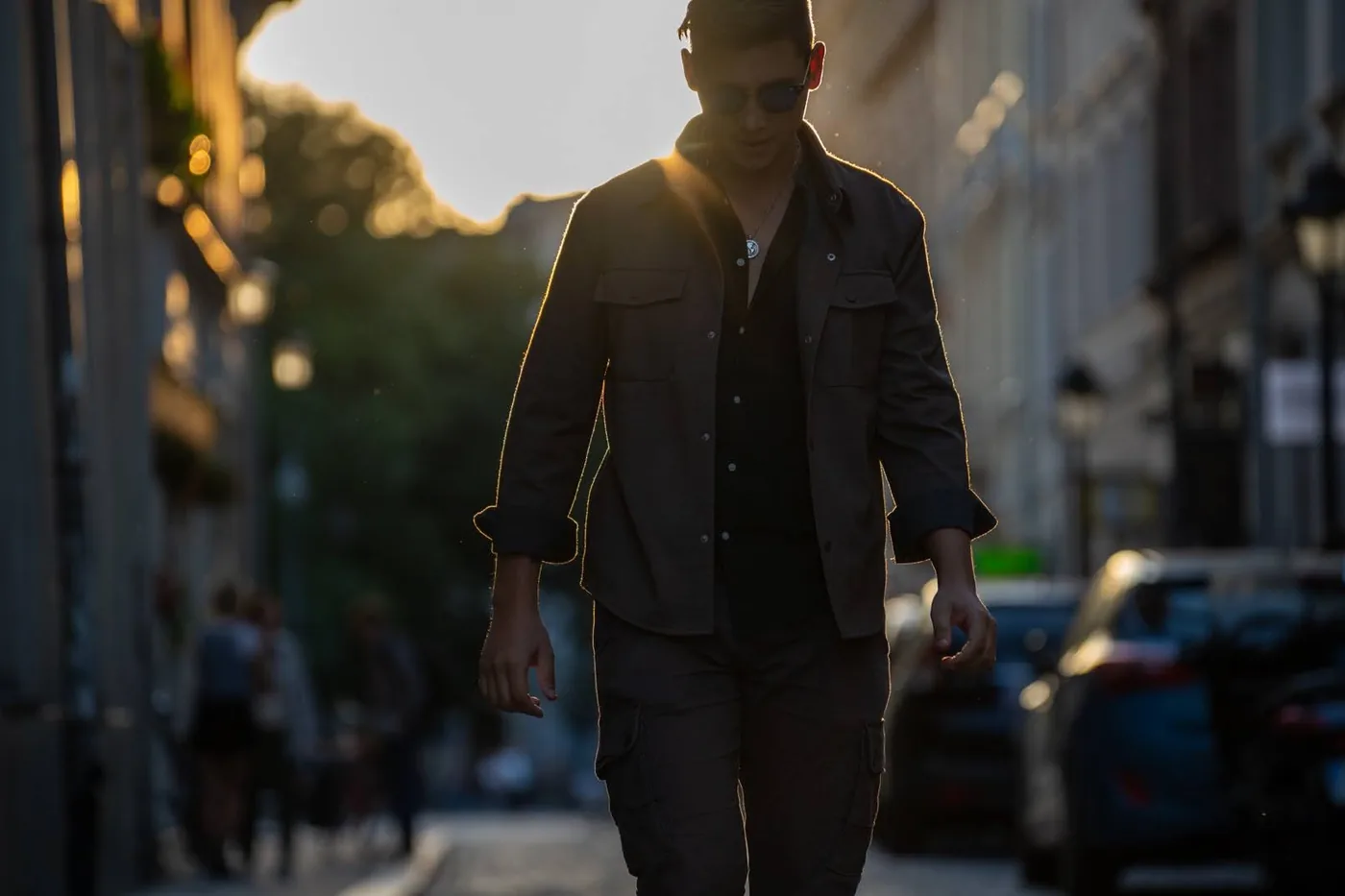 Luke Lawson walking down a city street at golden hour